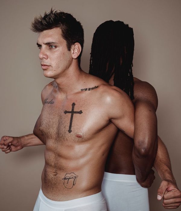 Man performing a controlled strength exercise in a minimalist studio.